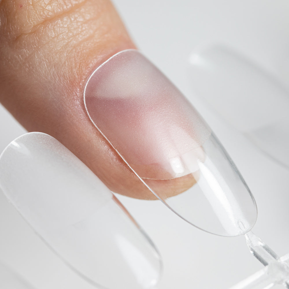 Läpinäkyvä AlleLac Flexi Tips Oval -kokokynnen tippi luonnonkynnen päällä